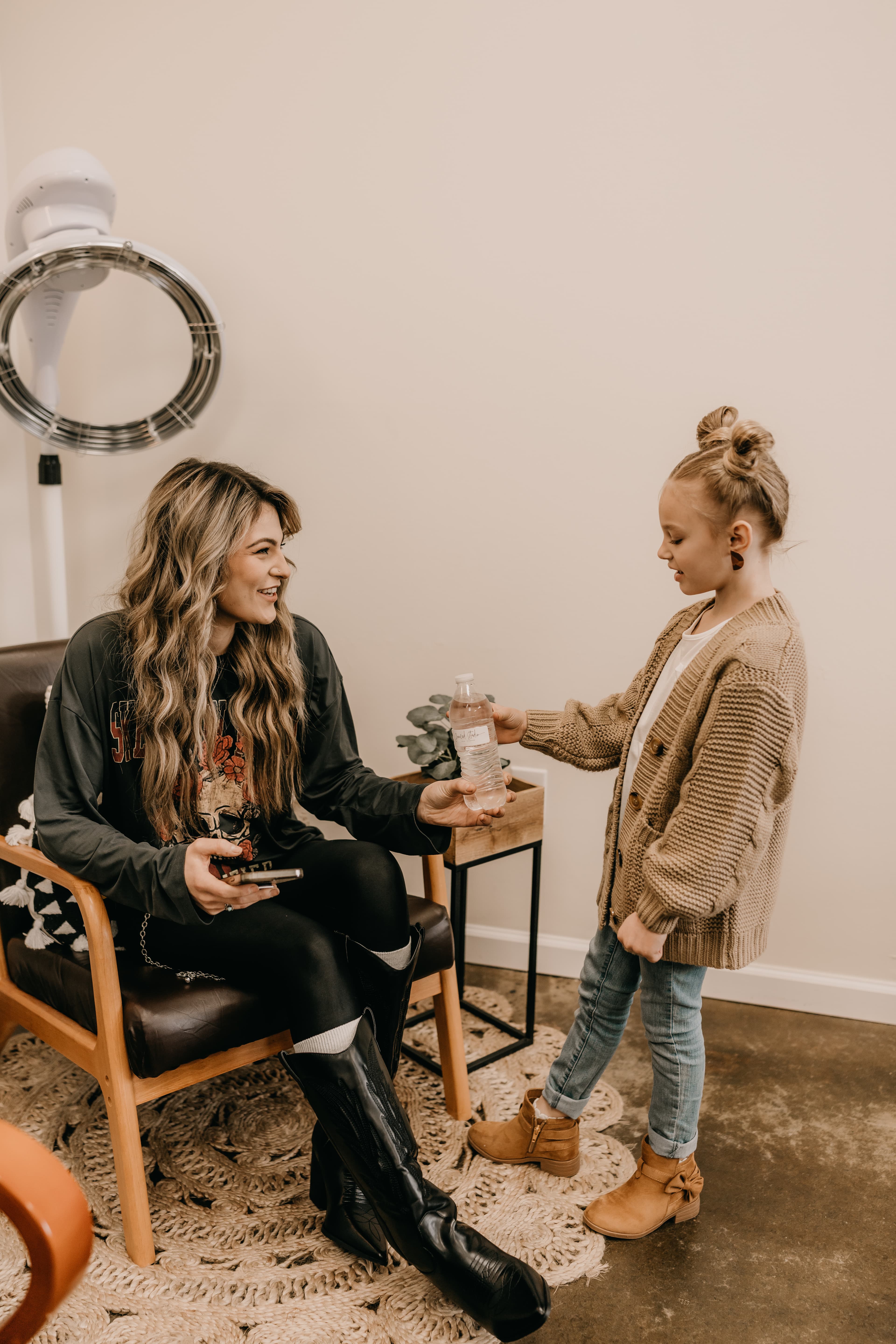 Young adult and child talking at Graced Studio